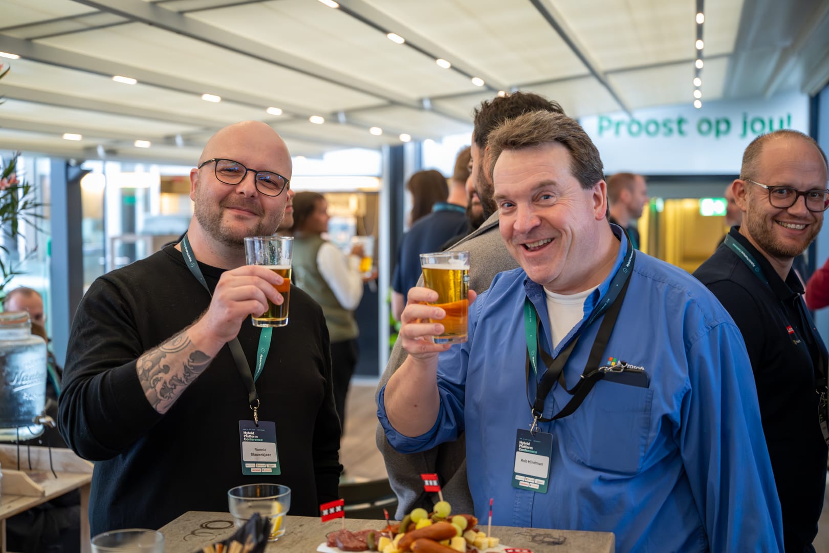Attendees raising a beer on the rooftop